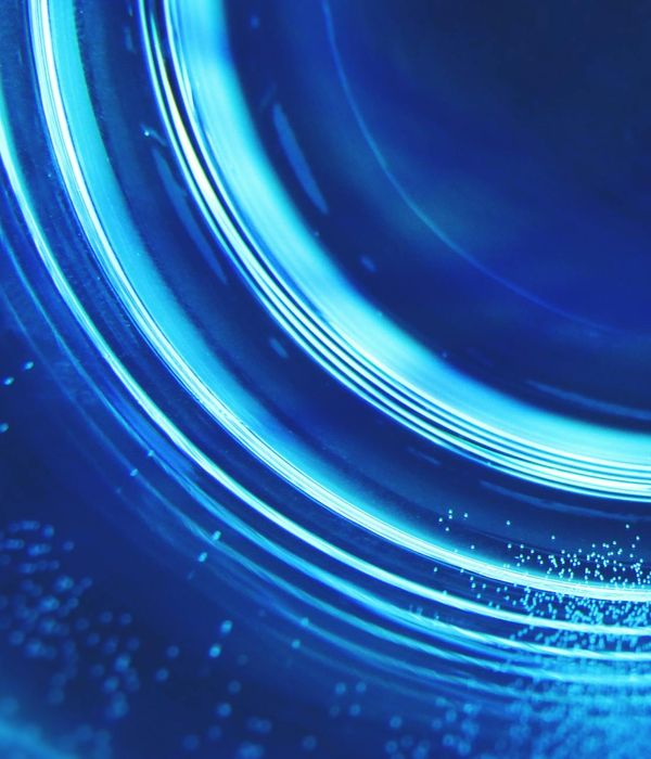Abstract glowing cyan waves in dark blue water