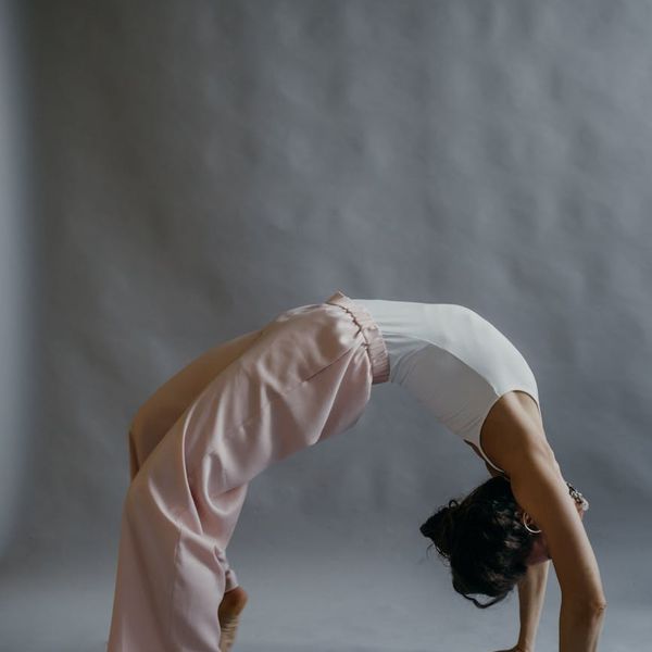 A person performing a gentle stretching yoga pose, showing flexibility.